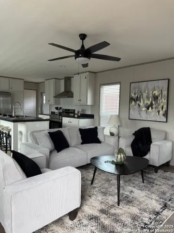 a living room with furniture or couch and a kitchen