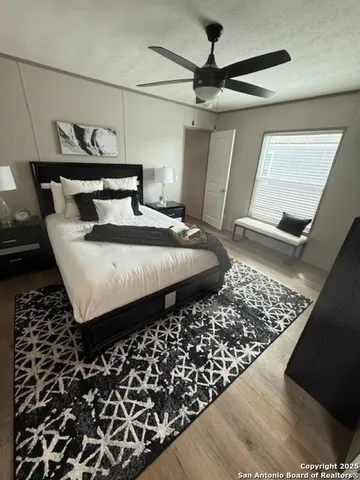 a bed sitting in a bedroom next to a window