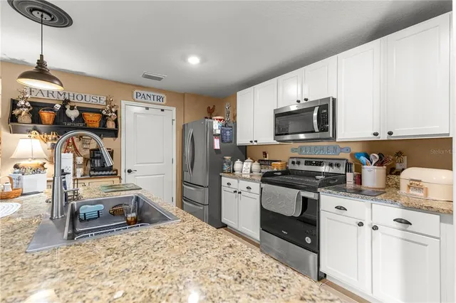 a view of a hallway with wooden floor and a workspace
