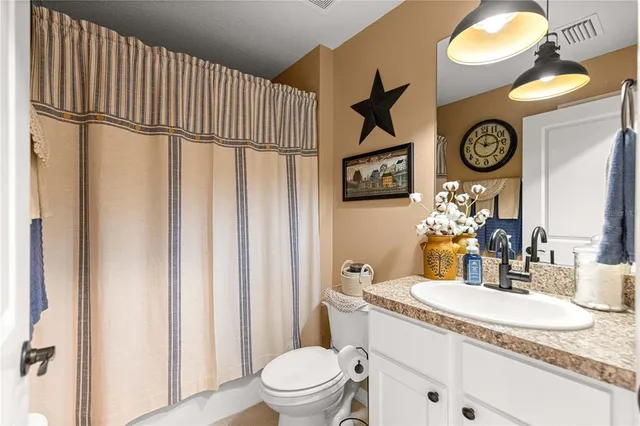 a view of a hallway with wooden floor and entryway