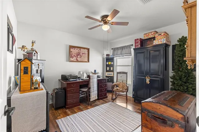 a kitchen with stainless steel appliances granite countertop a refrigerator a stove top oven a dining table and chairs with wooden floor