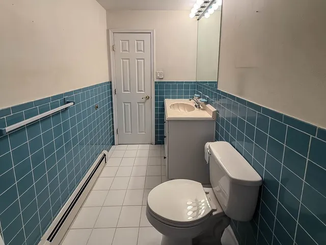 a bathroom with a toilet and a sink