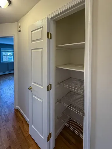 a view of walk in closet with empty racks