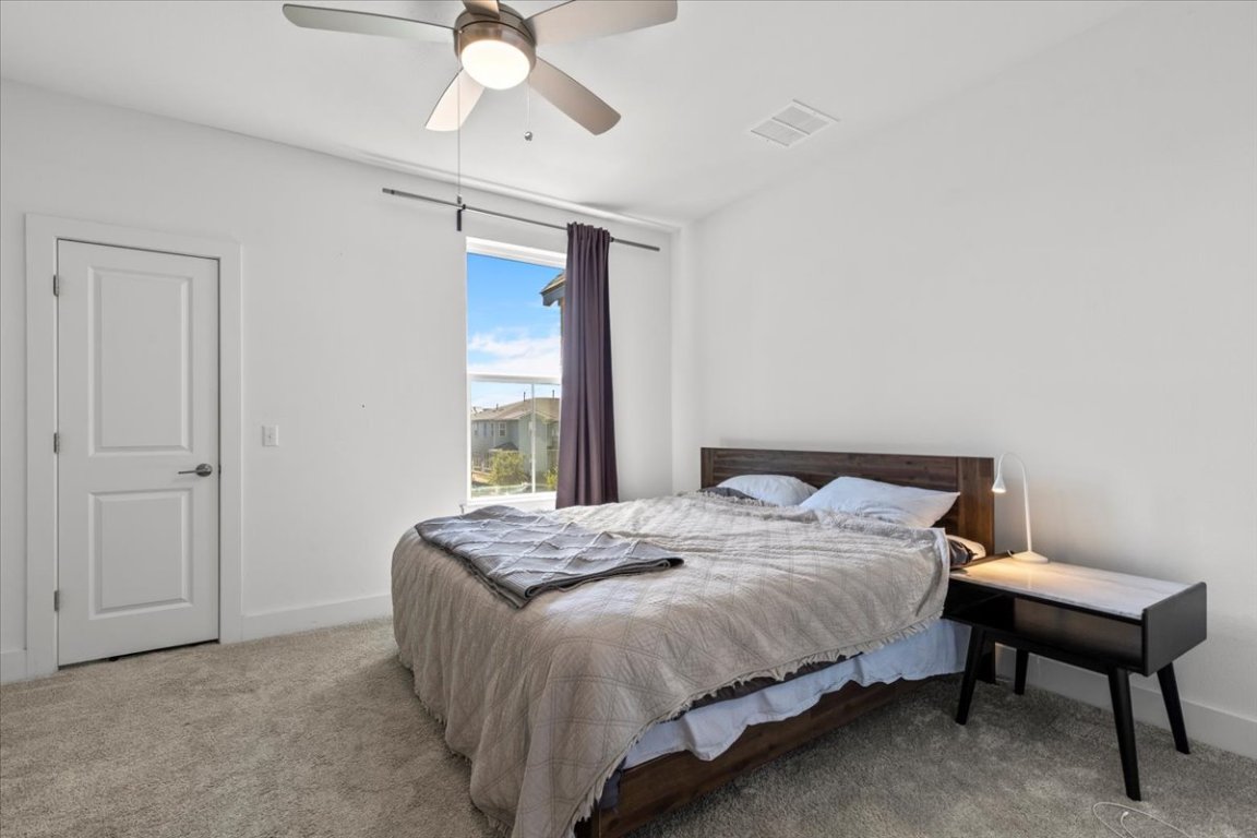 2516 Simond Avenue, Unit D Austin, TX 78723 - Photo 15 of 31 Primary Bedroom bright with Ceiling Fan.