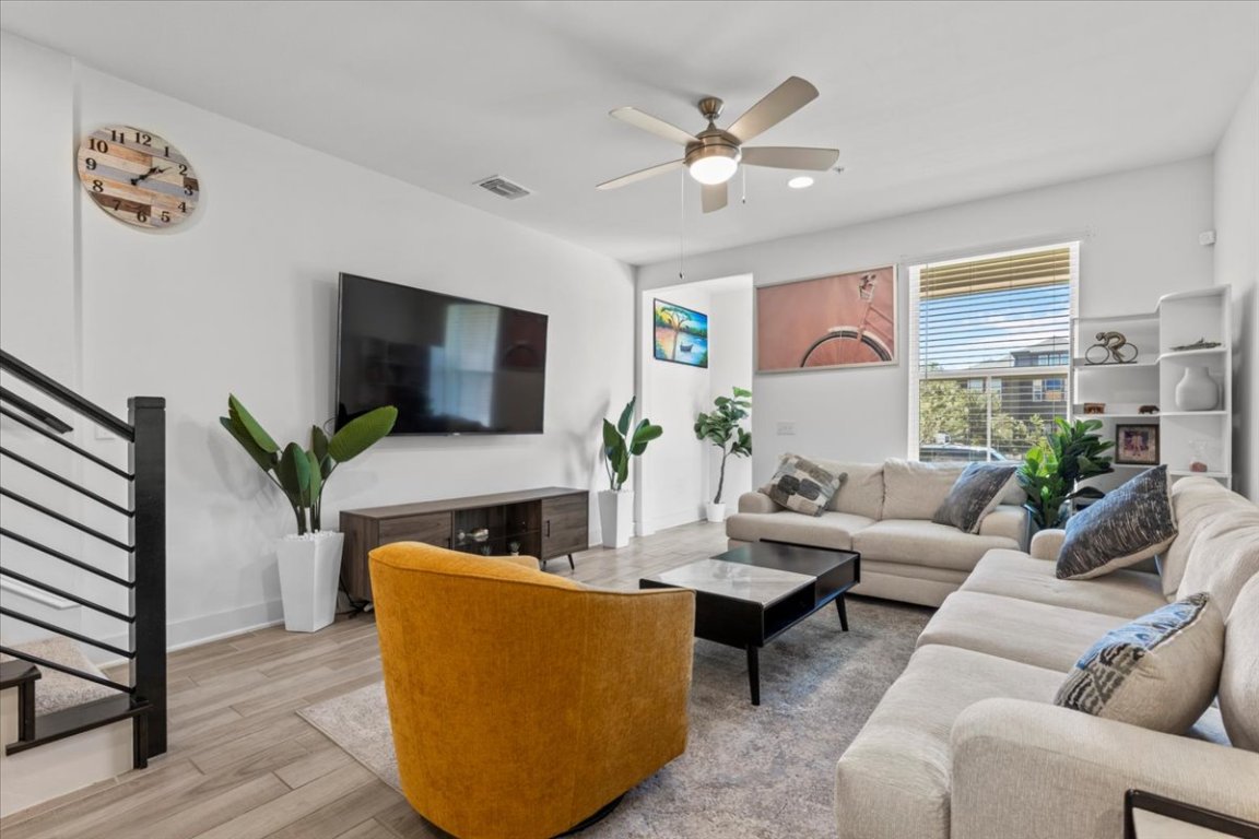 2516 Simond Avenue, Unit D Austin, TX 78723 - Photo 6 of 31 Living room with stairs, wood floors, and ceiling fan