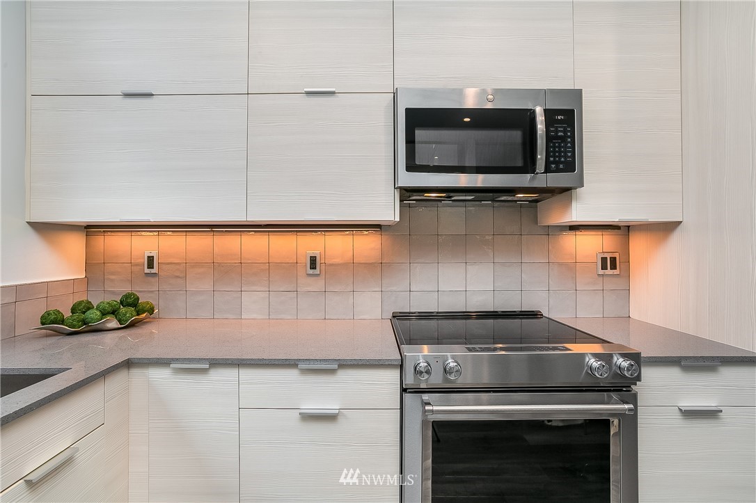 5257 Fauntleroy Way Southwest Seattle, WA 98136 - Photo 11 of 27 a kitchen with a stove and a microwave