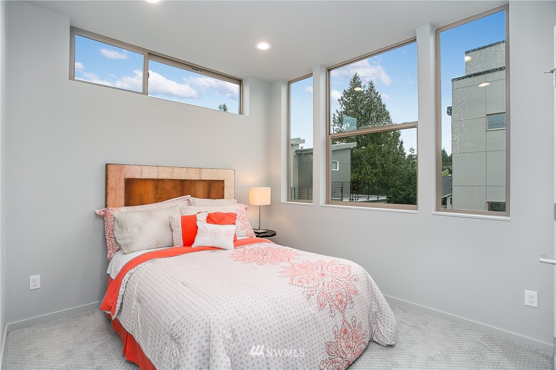 5257 Fauntleroy Way Southwest Seattle, WA 98136 - Photo 12 of 27 a bedroom with a bed and a large window