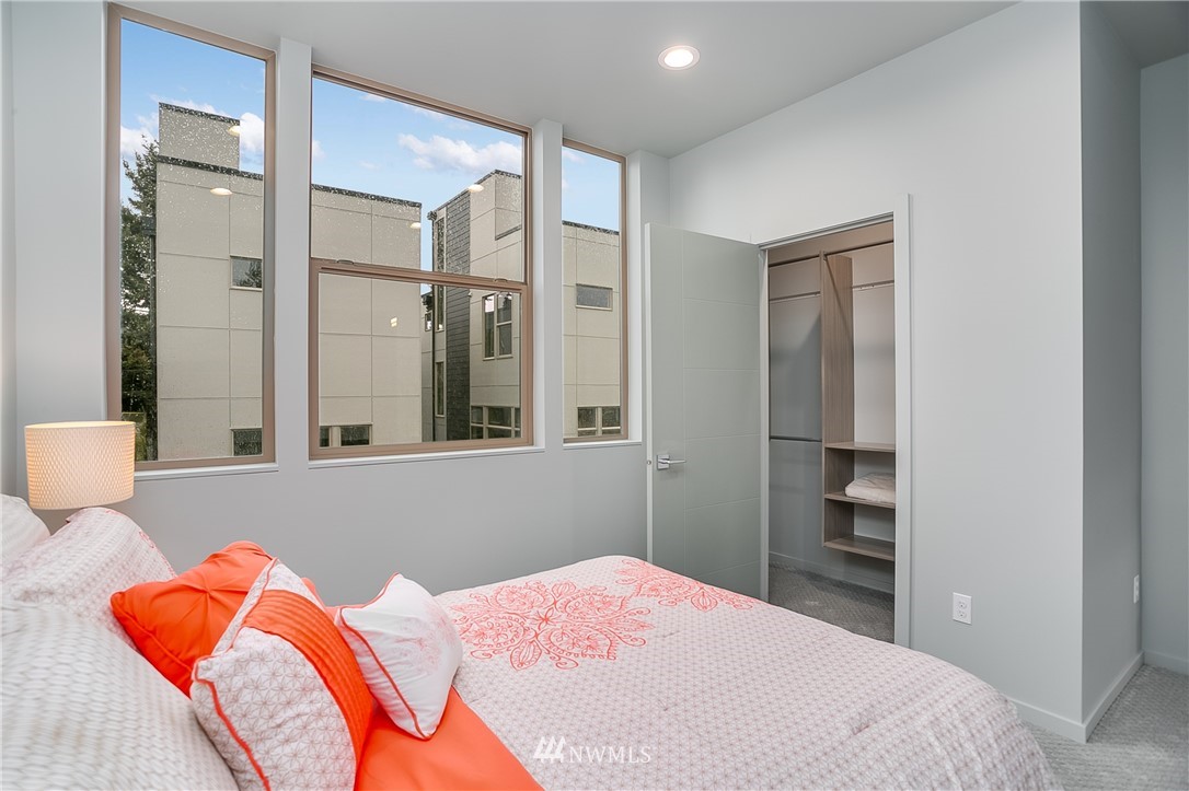 5257 Fauntleroy Way Southwest Seattle, WA 98136 - Photo 13 of 27 a bedroom with a bed and a lamp