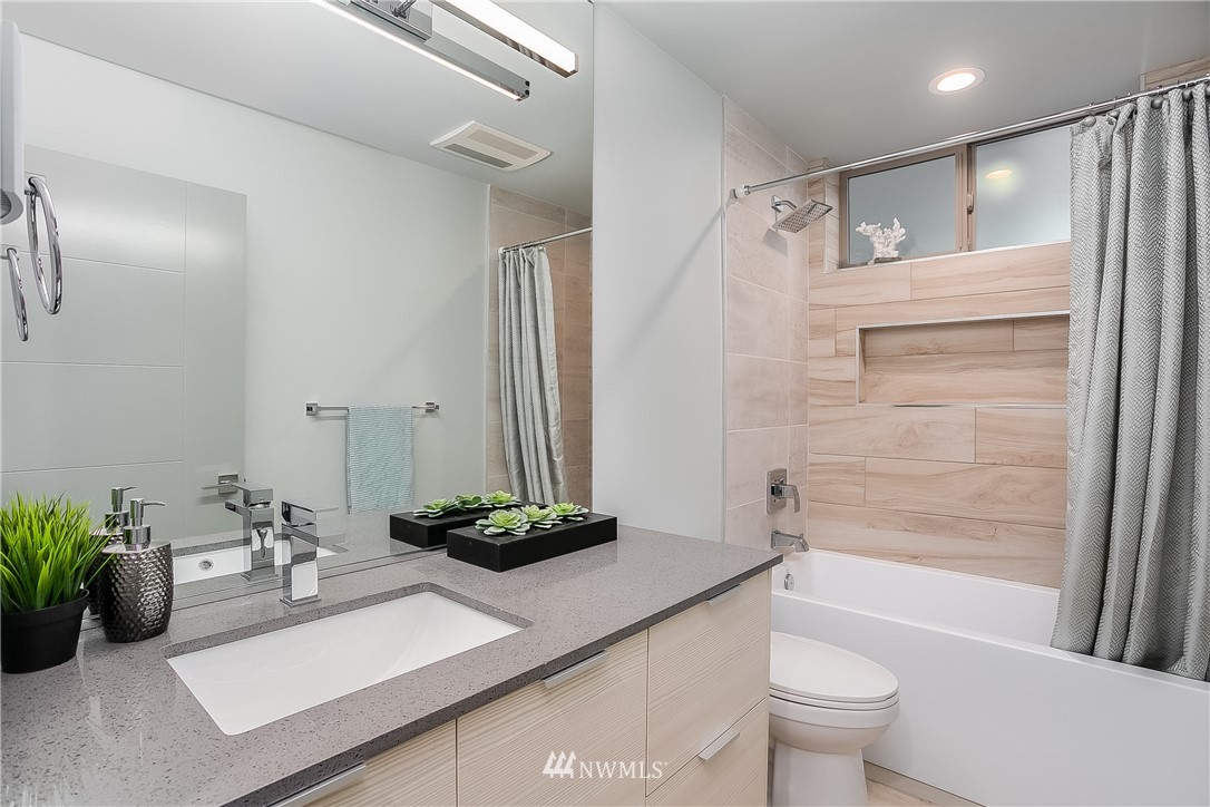 5257 Fauntleroy Way Southwest Seattle, WA 98136 - Photo 17 of 27 a bathroom with a sink a toilet and shower
