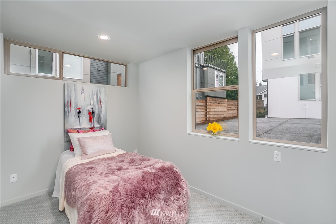 5257 Fauntleroy Way Southwest Seattle, WA 98136 - Photo 18 of 27 a bedroom with a bed and a window