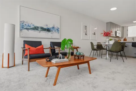 a living room with furniture and a painting on the wall