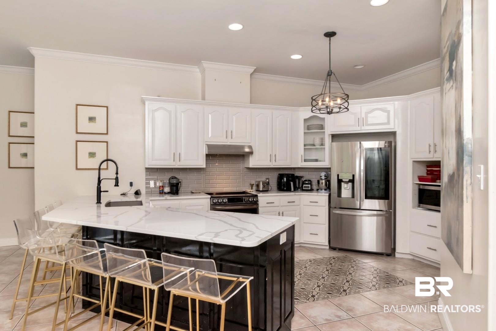 2640 Meadowlake Road Semmes, AL 36575 - Photo 15 of 55 Two tone kitchen with a peninsula, stainless steel appliances, a kitchen bar, light stone countertops, and glass insert cabinets