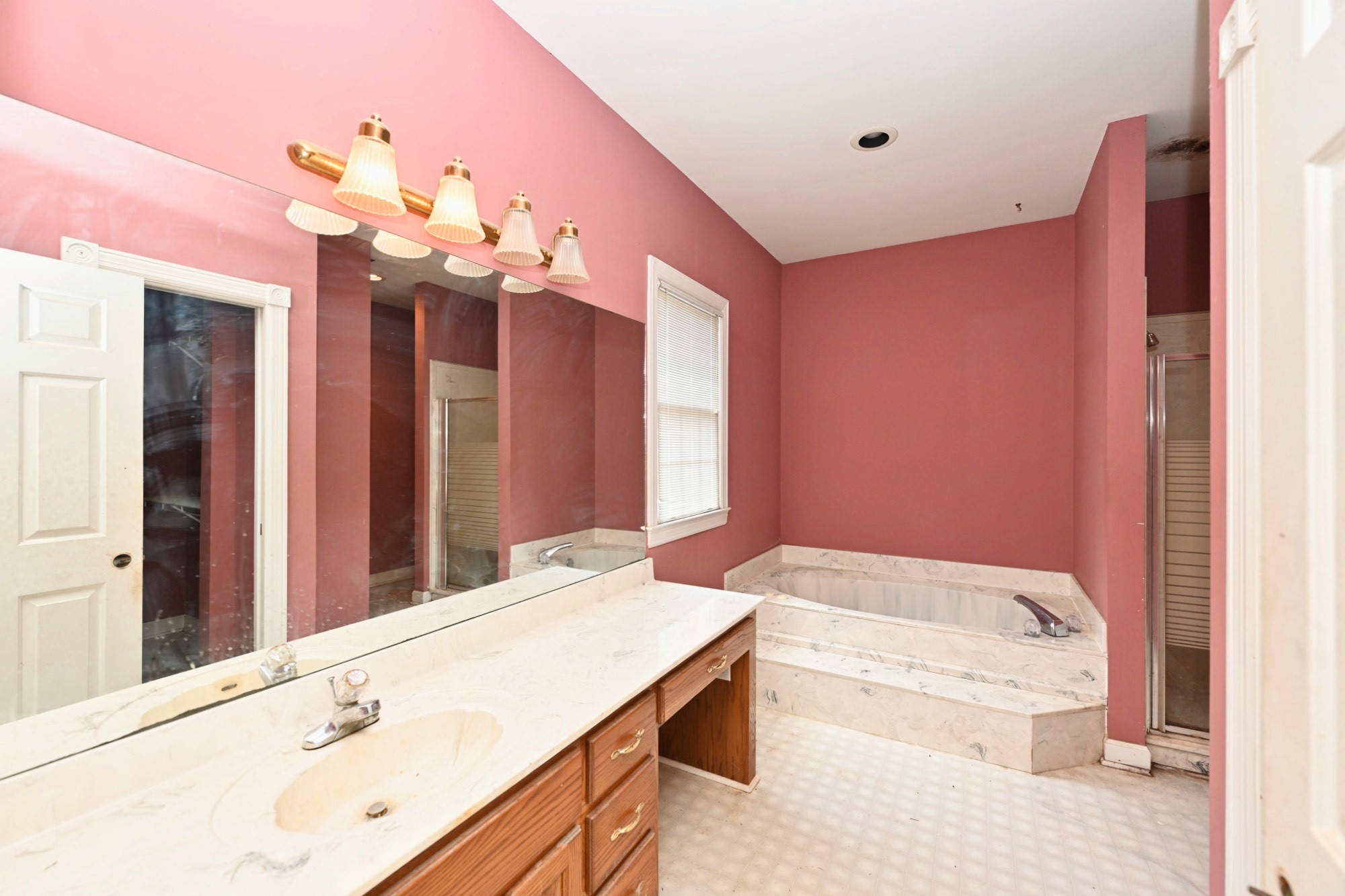 795 New Shackle Island Road Hendersonville, TN 37075 - Photo 16 of 41 a bathroom with a tub a sink and a large mirror