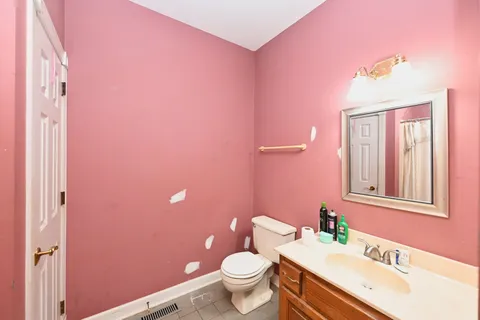 a bathroom with a granite countertop sink mirror and toilet