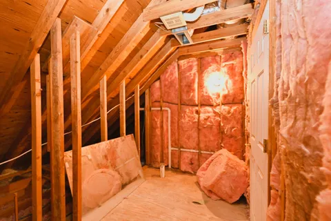 a bedroom with a bed and a curtain