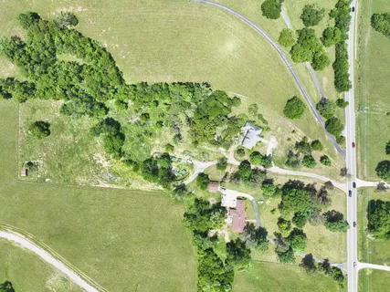 a view of field with trees in the background