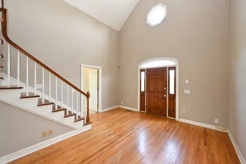 a view of an entryway with wooden floor