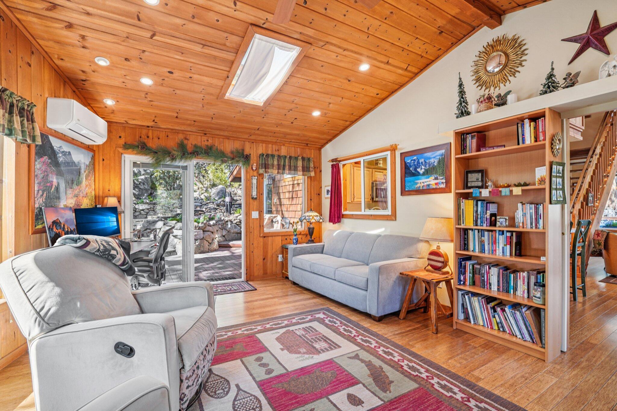 25361 Skyline Way Idyllwild, CA 92549 - Photo 11 of 42 a living room with furniture and a book shelf