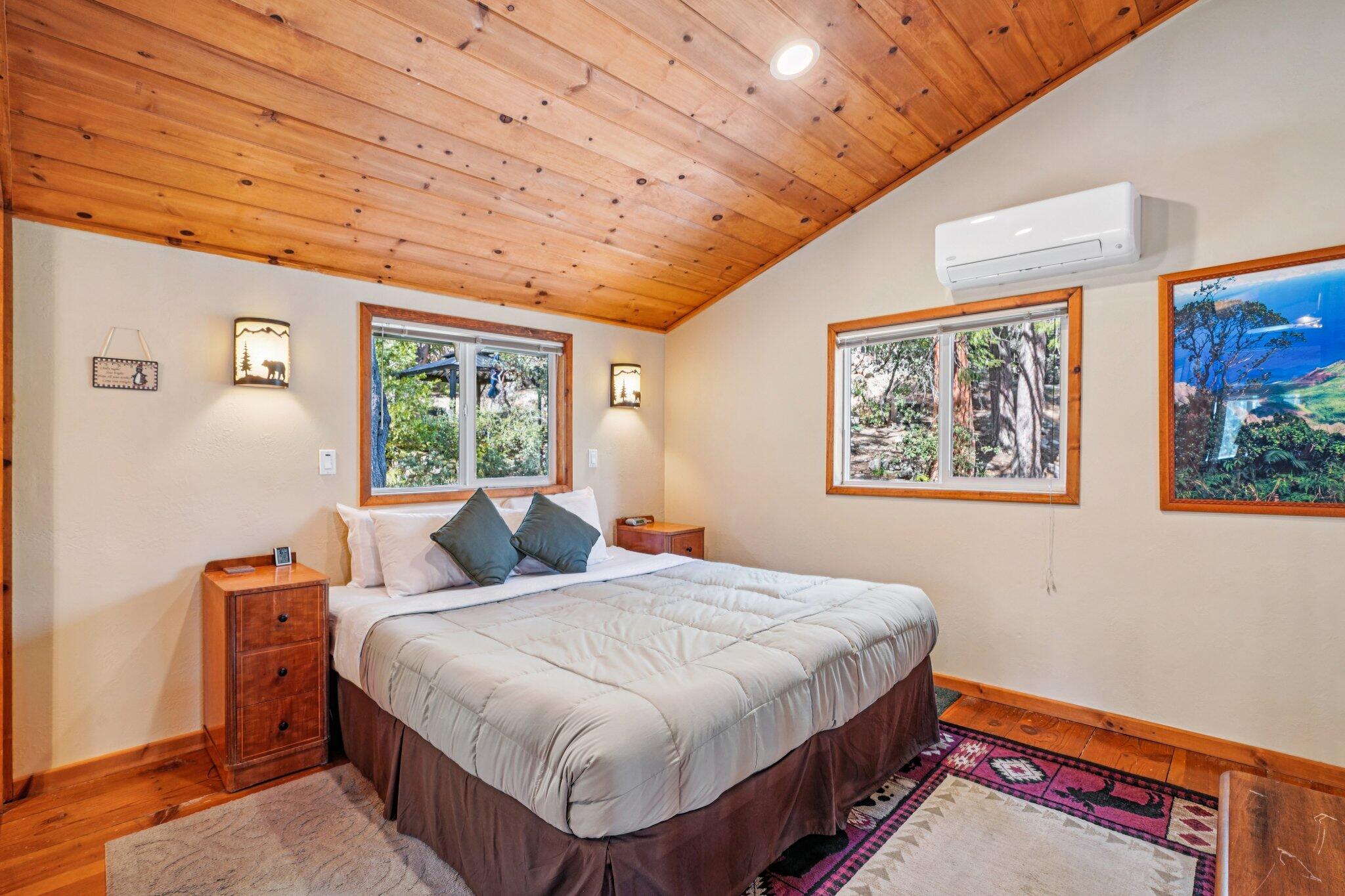 25361 Skyline Way Idyllwild, CA 92549 - Photo 22 of 42 a bedroom with a bed a window and painting on the wall