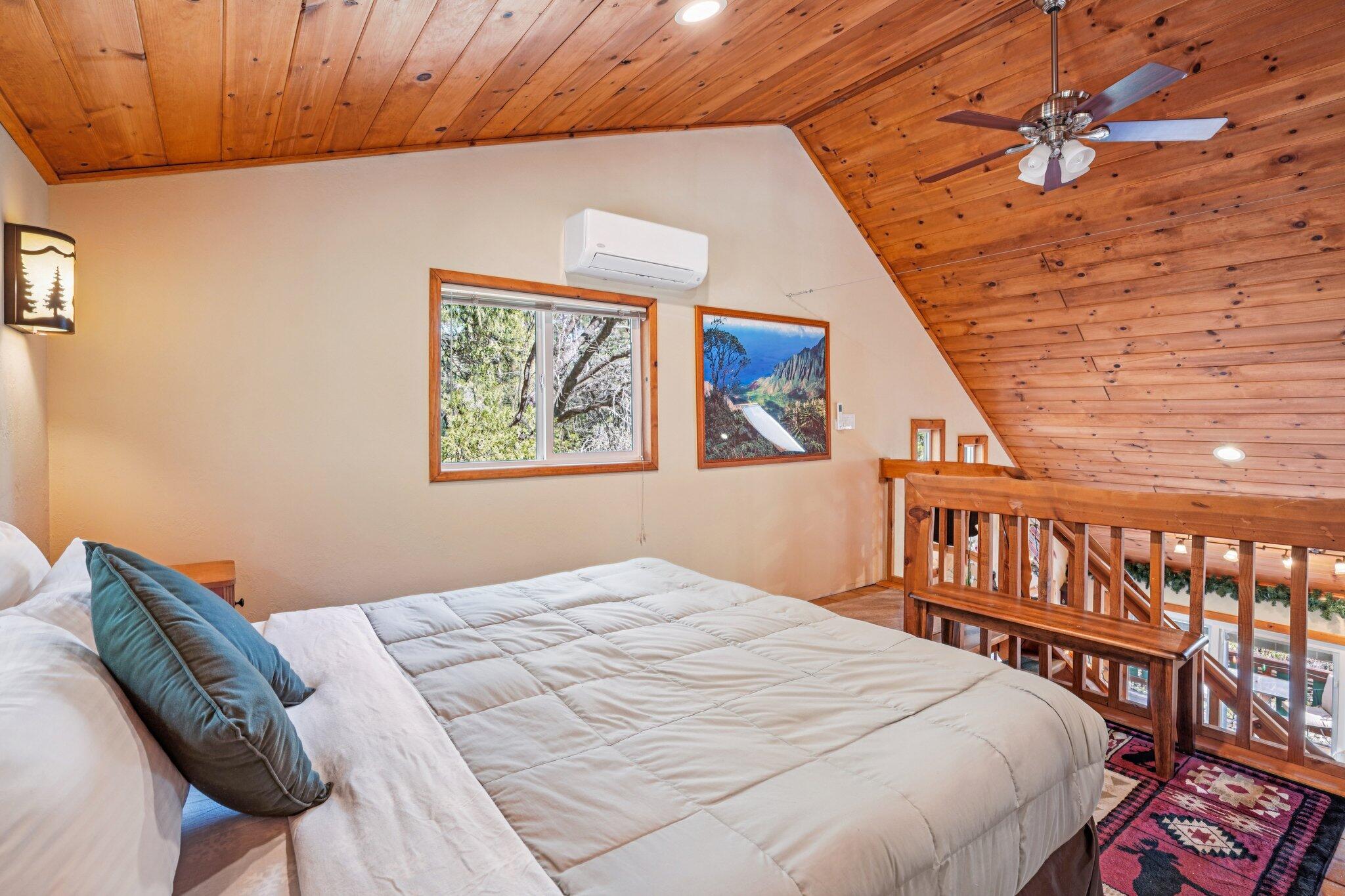 25361 Skyline Way Idyllwild, CA 92549 - Photo 23 of 42 a bedroom with a bed and wooden floor