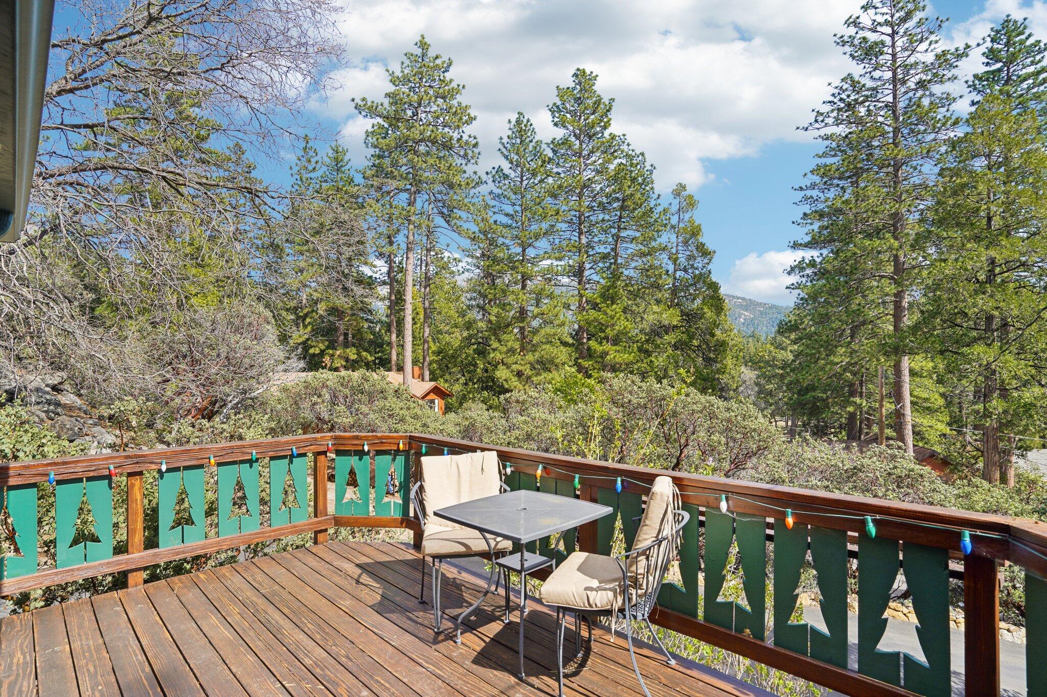 25361 Skyline Way Idyllwild, CA 92549 - Photo 31 of 42 a balcony with wooden floor outdoor seating and yard in the back