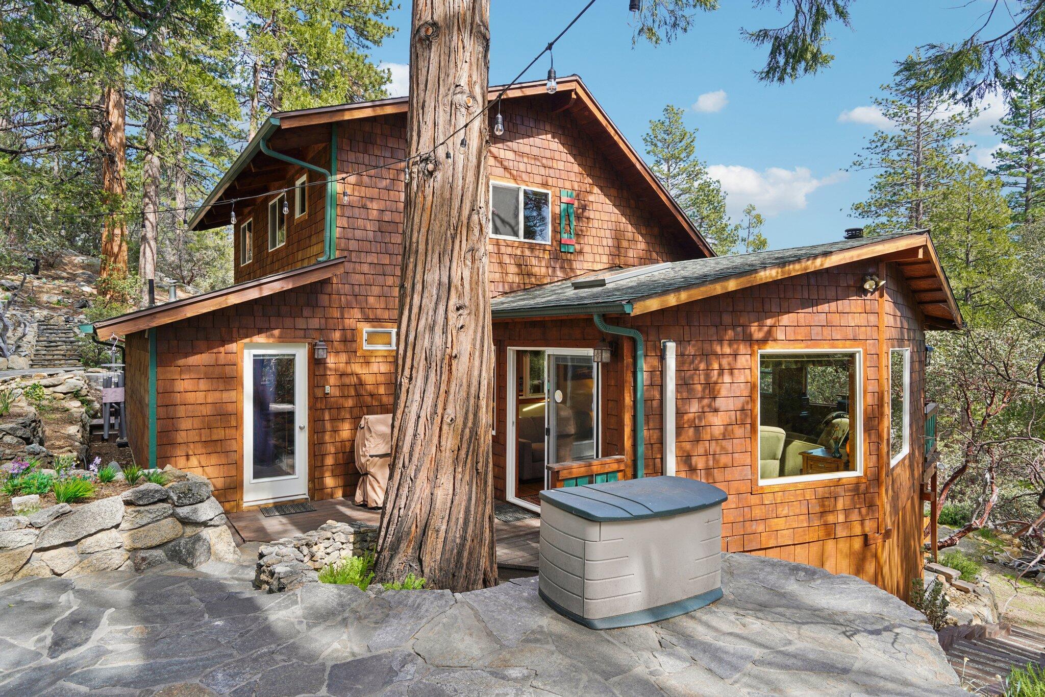 25361 Skyline Way Idyllwild, CA 92549 - Photo 33 of 42 a view of a white house with large windows and plants