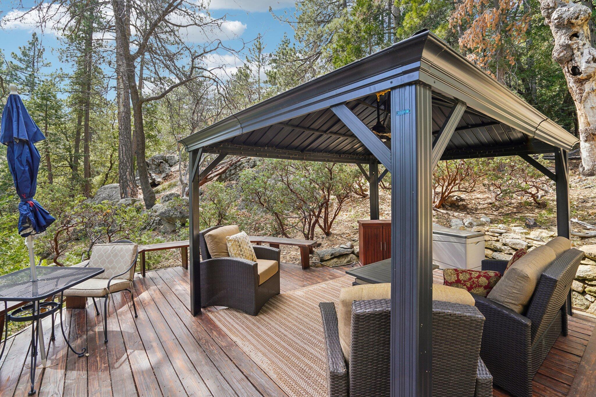 25361 Skyline Way Idyllwild, CA 92549 - Photo 37 of 42 a view of deck with table and chairs under an umbrella with wooden floor