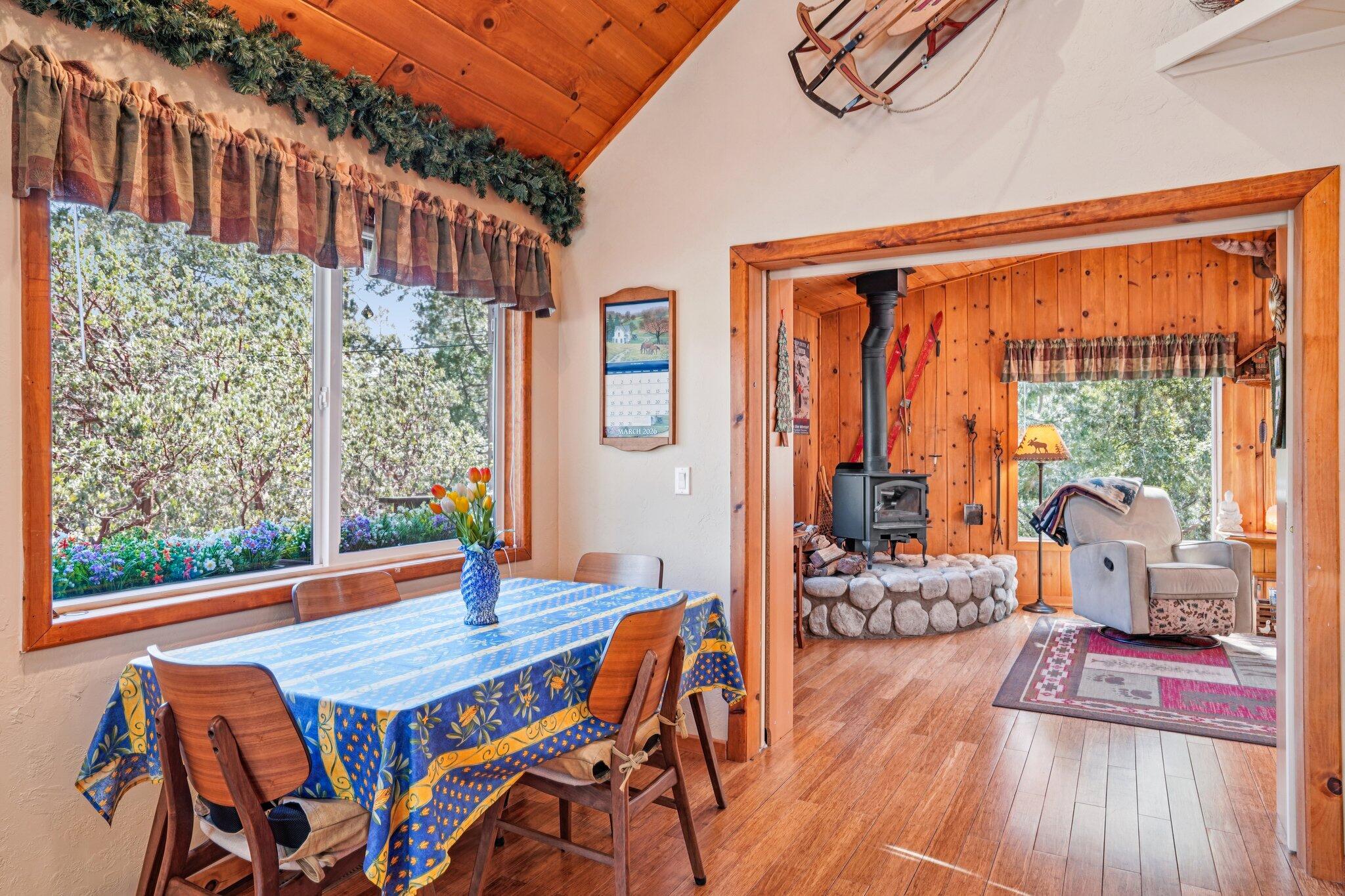 25361 Skyline Way Idyllwild, CA 92549 - Photo 7 of 42 a view of a dining room with furniture water view and wooden floor