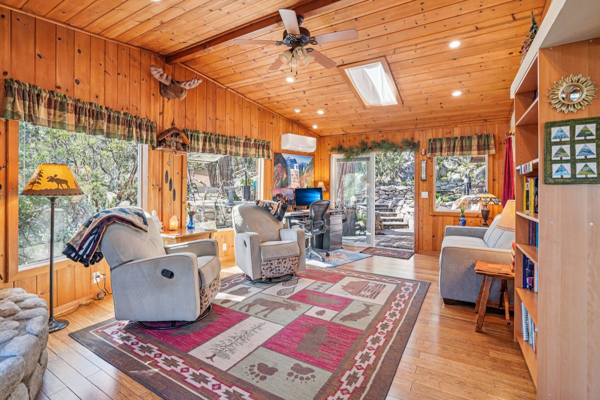 25361 Skyline Way Idyllwild, CA 92549 - Photo 9 of 42 a living room with furniture a rug and a chandelier