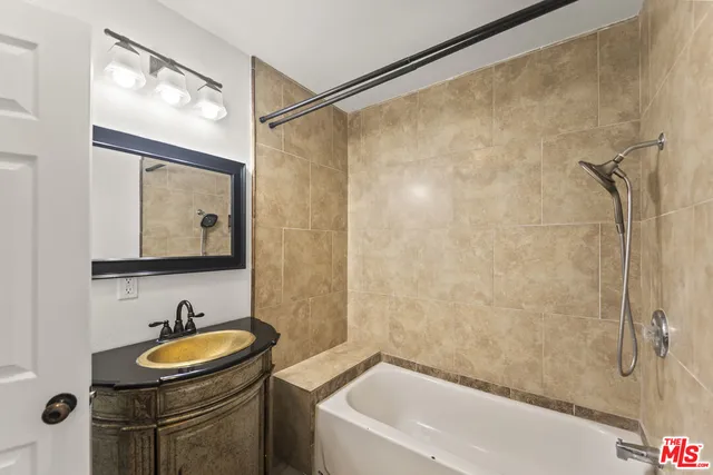 a bathroom with a sink and a mirror a bathtub