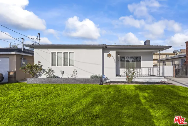 a view of a house with a yard and a garden