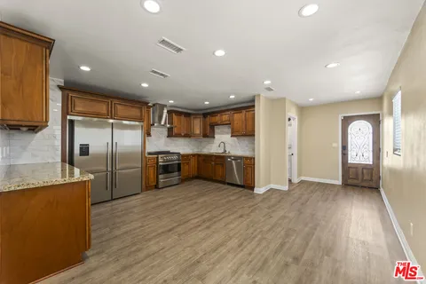 a kitchen with a refrigerator and a sink
