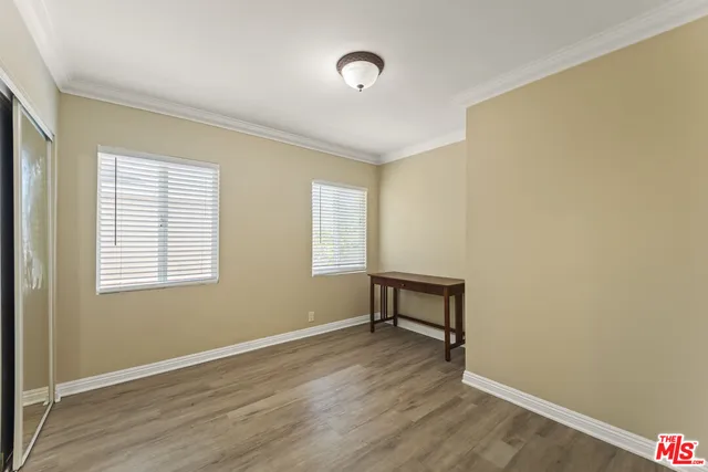 a view of a room with wooden floor and a window