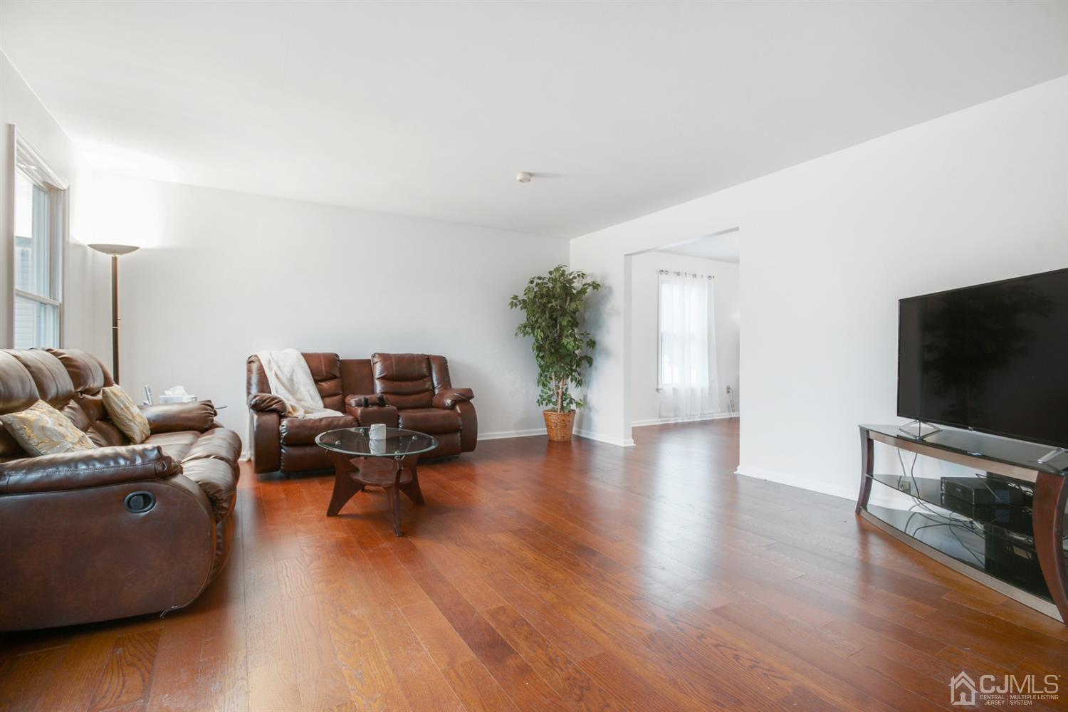 188 Plainfield Road Edison, NJ 08820 - Photo 3 of 16 a living room with furniture wooden floor and a flat screen tv