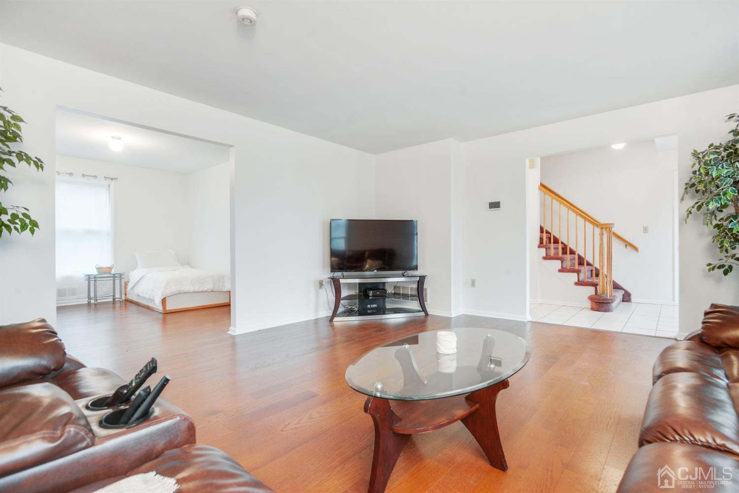 188 Plainfield Road Edison, NJ 08820 - Photo 4 of 16 a living room with furniture and a flat screen tv