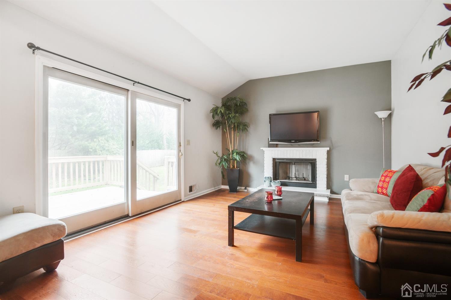 188 Plainfield Road Edison, NJ 08820 - Photo 7 of 16 a living room with furniture a fireplace and a large window
