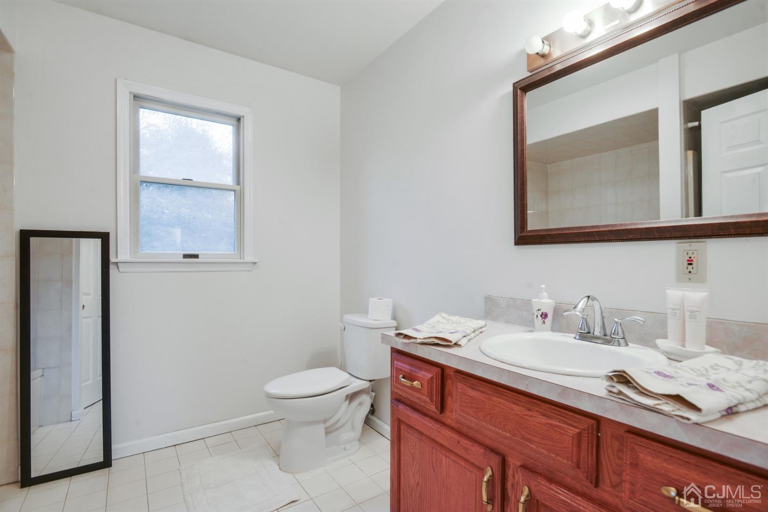188 Plainfield Road Edison, NJ 08820 - Photo 10 of 16 a bathroom with a granite countertop sink mirror vanity and toilet
