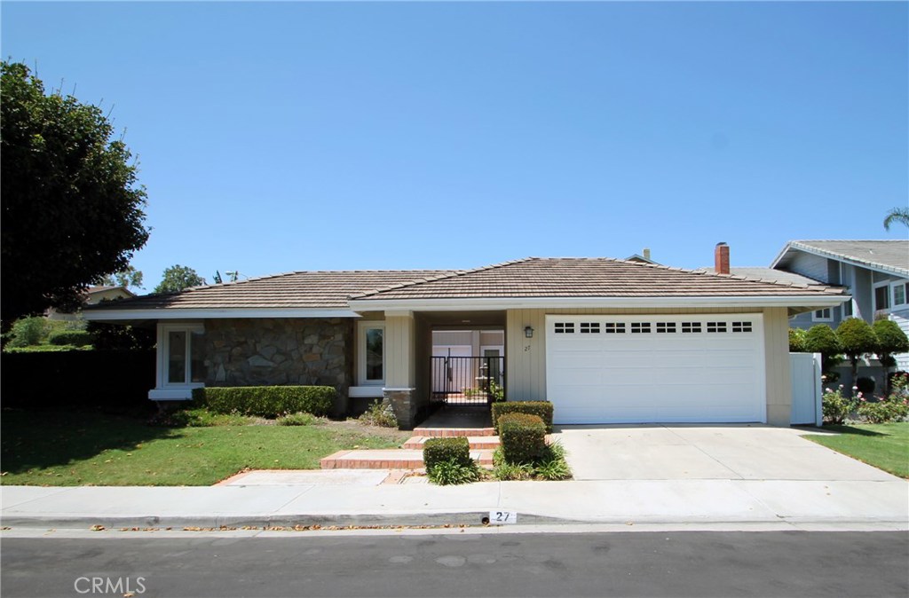 a front view of a house with a yard and a garage