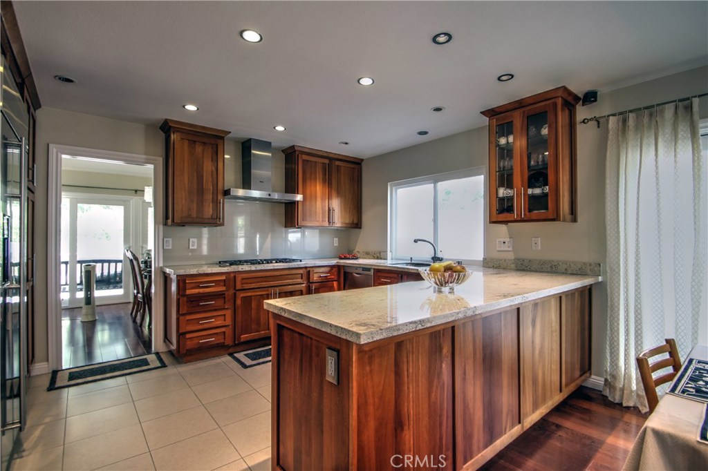 27 Silver Crescent Irvine, CA 92603 - Photo 11 of 30 a kitchen with a sink stove and cabinets