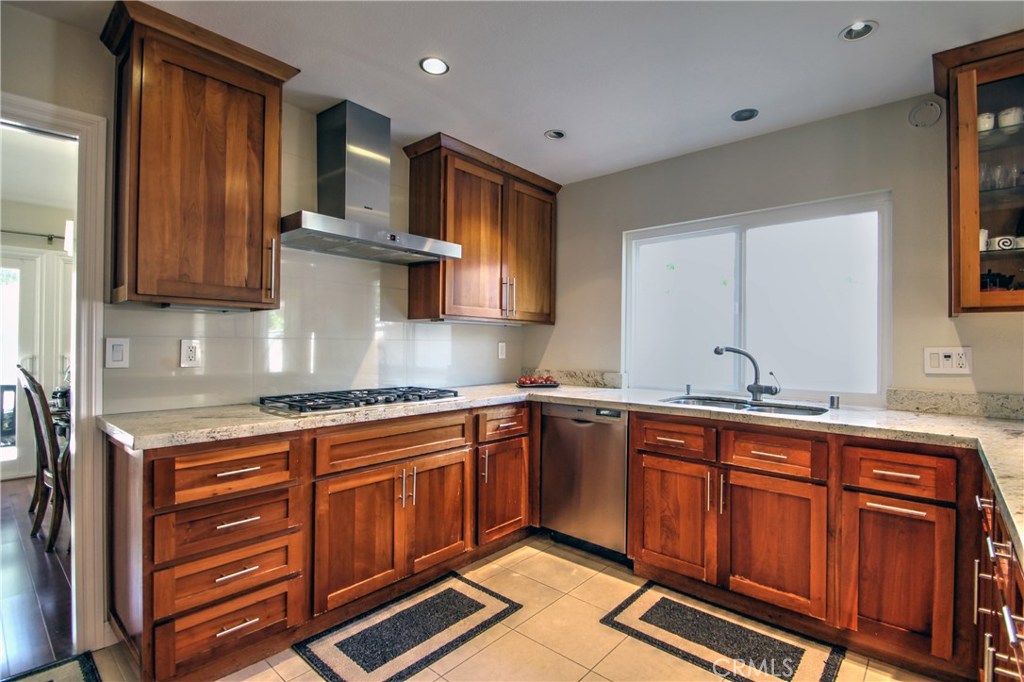 27 Silver Crescent Irvine, CA 92603 - Photo 15 of 30 a kitchen with stainless steel appliances granite countertop a sink stove and cabinets