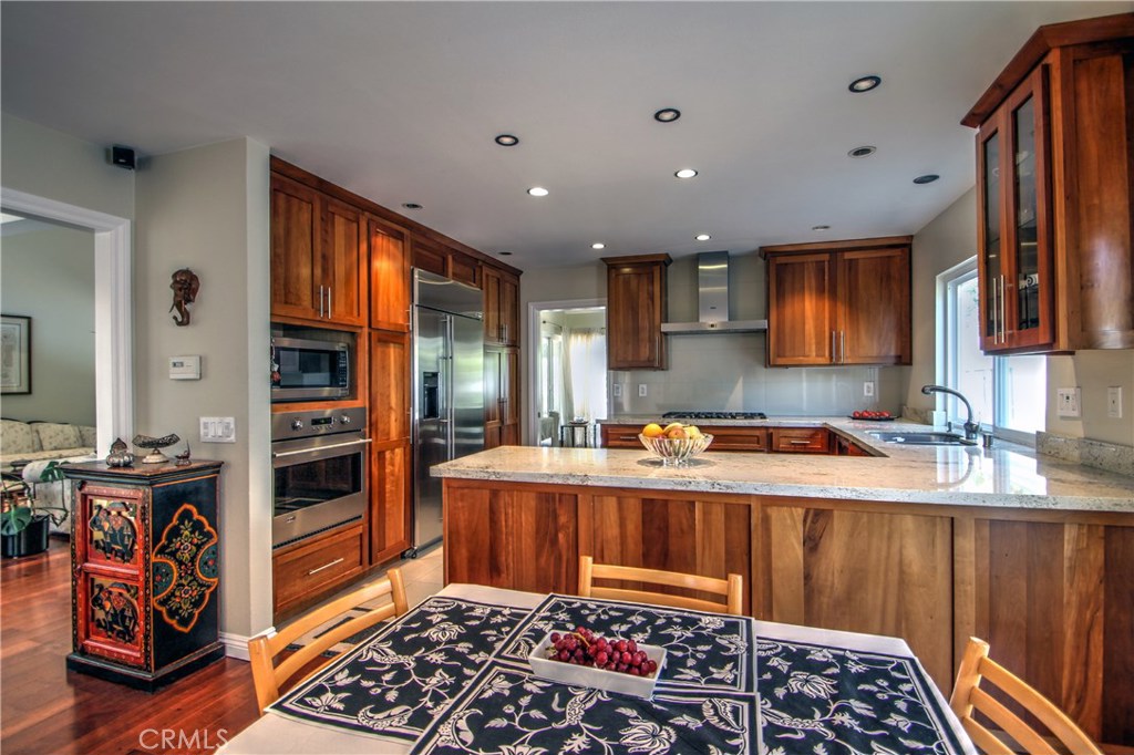 27 Silver Crescent Irvine, CA 92603 - Photo 16 of 30 a kitchen with stainless steel appliances granite countertop a stove a sink and a microwave