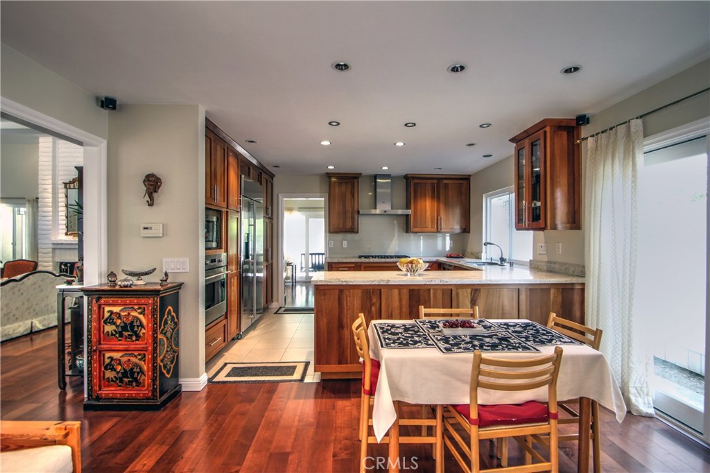 27 Silver Crescent Irvine, CA 92603 - Photo 17 of 30 a large kitchen with a table and chairs