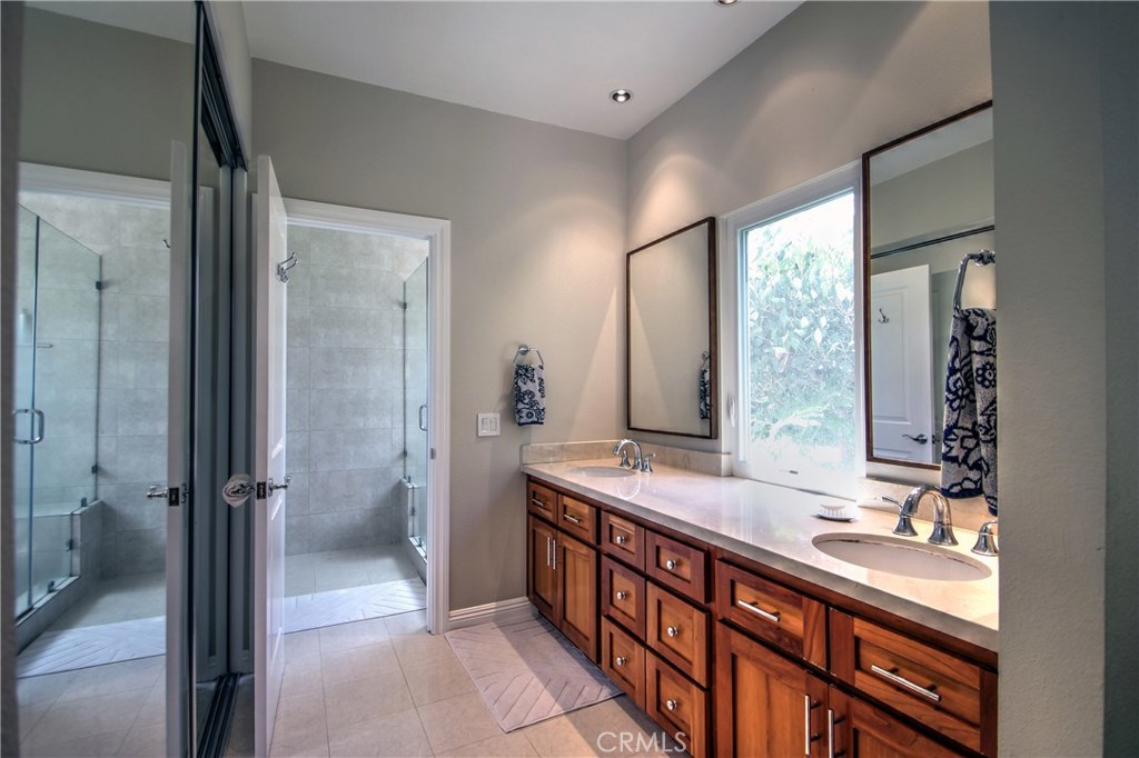 27 Silver Crescent Irvine, CA 92603 - Photo 20 of 30 a bathroom with a double vanity sink toilet mirror and windows