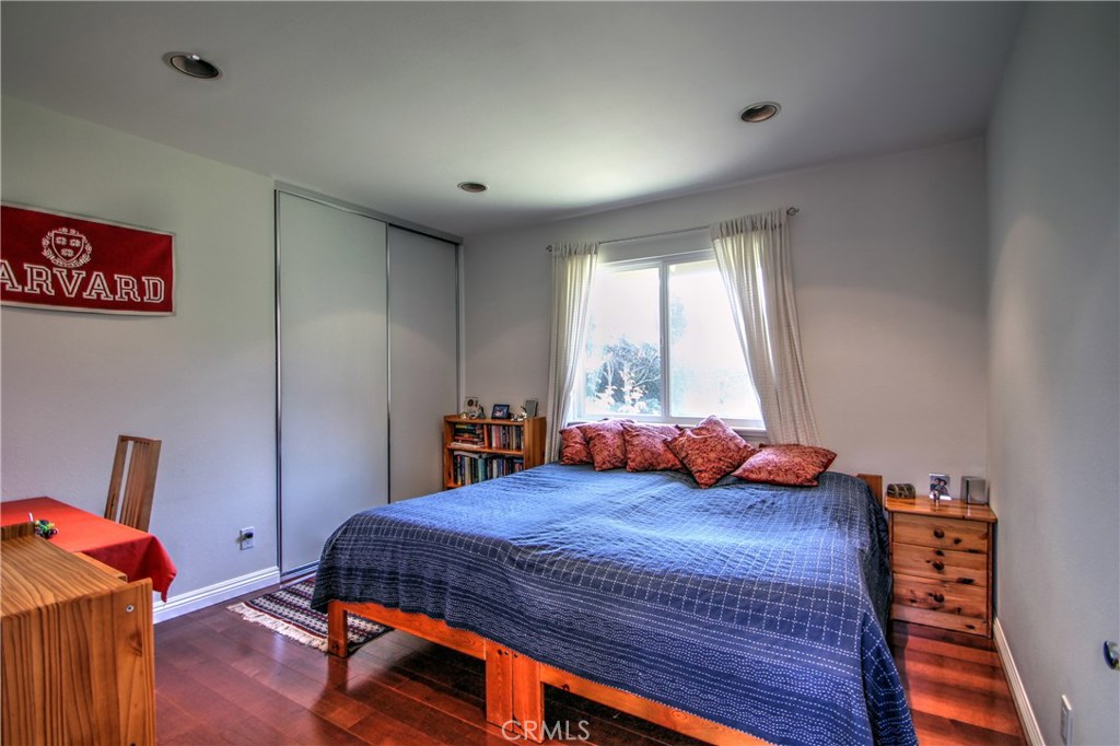 27 Silver Crescent Irvine, CA 92603 - Photo 22 of 30 a bedroom with a bed and wooden floor