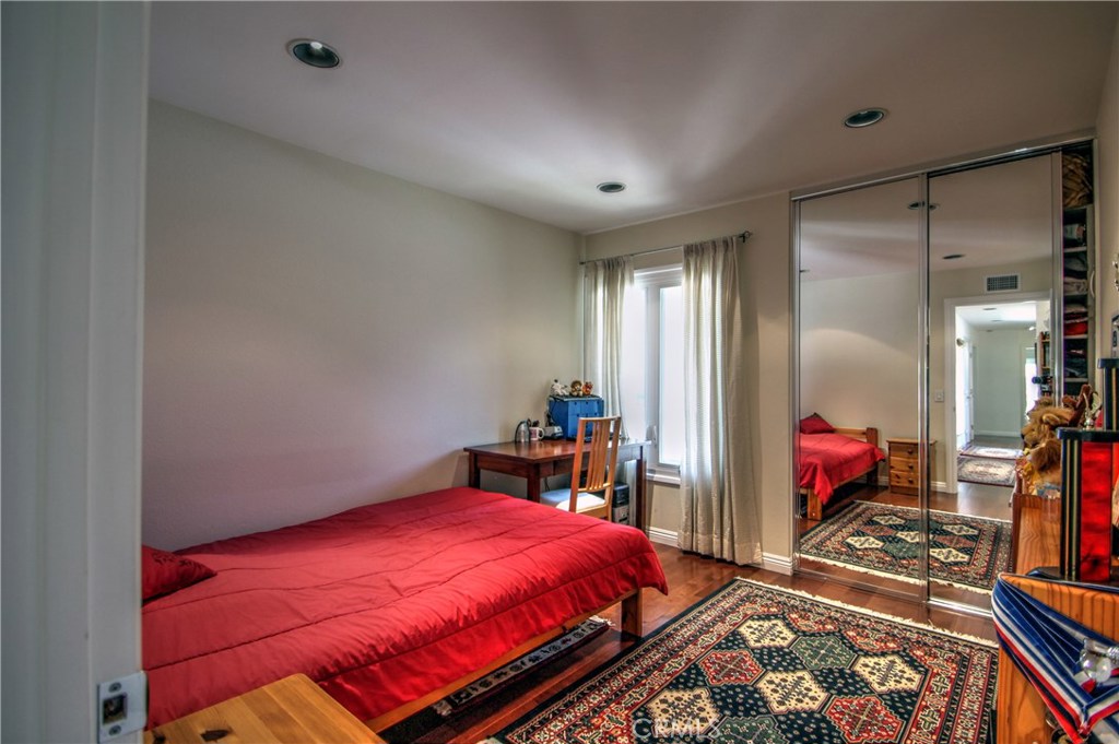 27 Silver Crescent Irvine, CA 92603 - Photo 23 of 30 a bed room with a bed and a chandelier