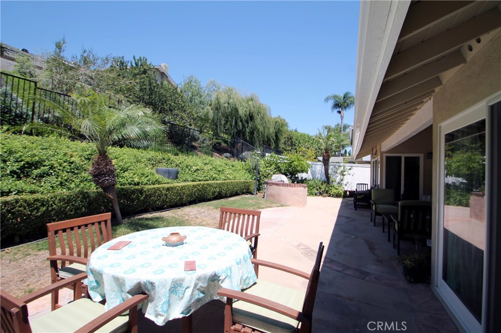 27 Silver Crescent Irvine, CA 92603 - Photo 26 of 30 a view of a patio with table and chairs and potted plants