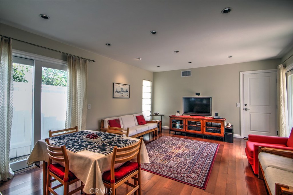 27 Silver Crescent Irvine, CA 92603 - Photo 9 of 30 a living room with furniture a flat screen tv and a table