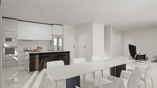 a kitchen with a sink cabinets and wooden floor