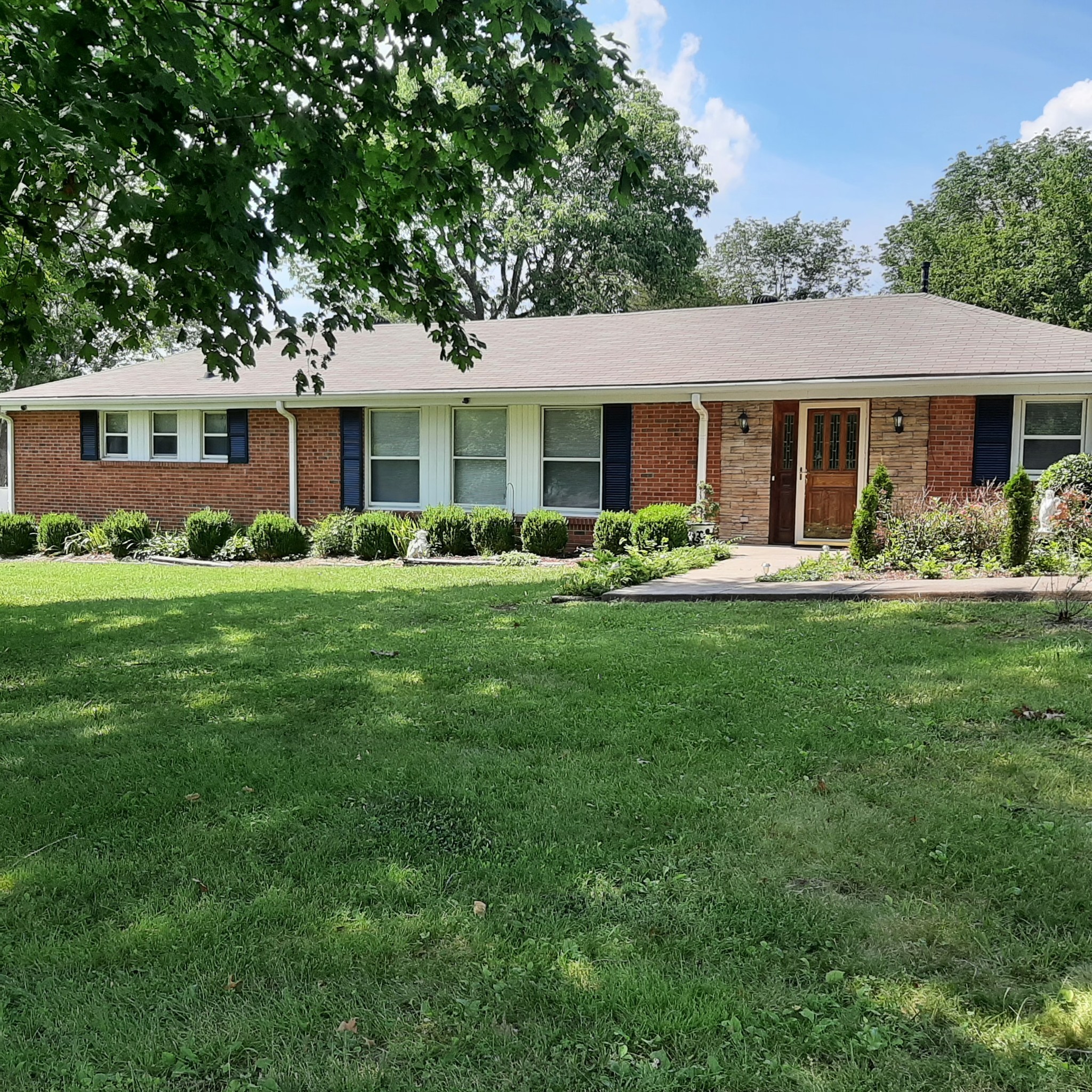 a front view of a house with a garden