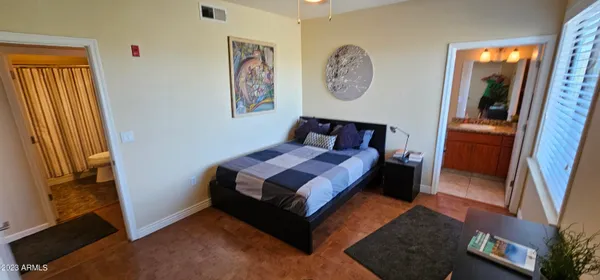 a bed sitting in a bedroom next to a window